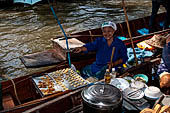 Thailand, Locals sell fruits, food and products at Damnoen Saduak floating market near Bangkok 